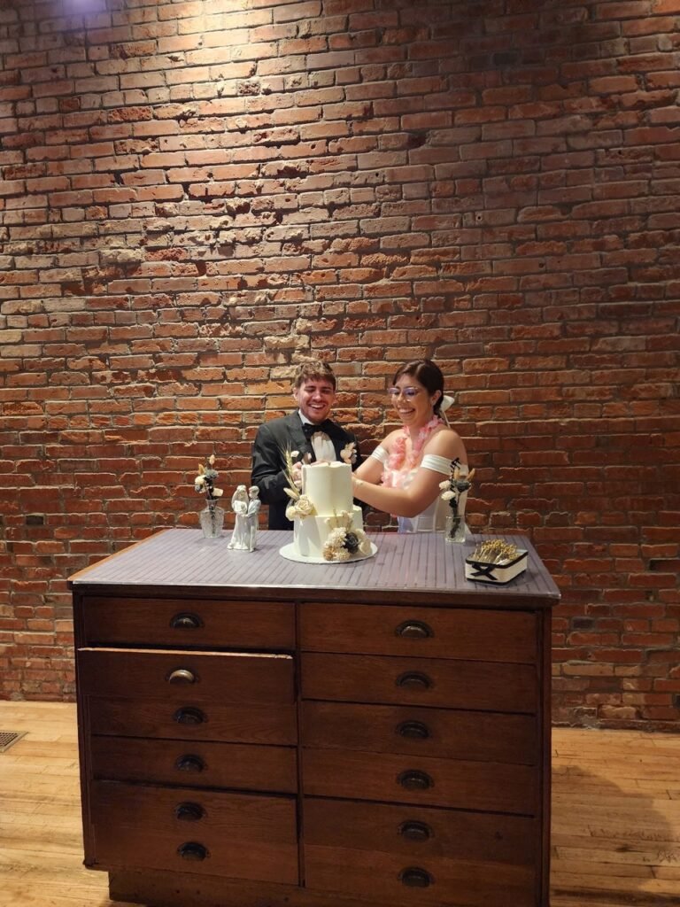 a happy copoule cutting their wedding cake happy clients valenbakes