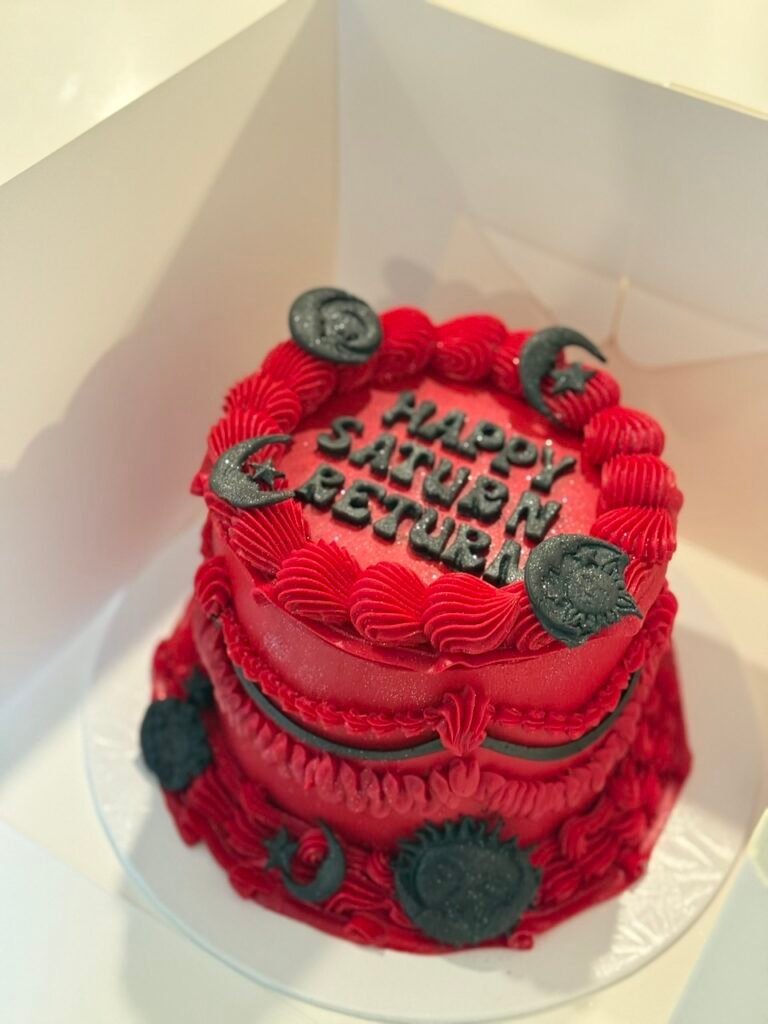 custom zodiac red cake with black details so vintage